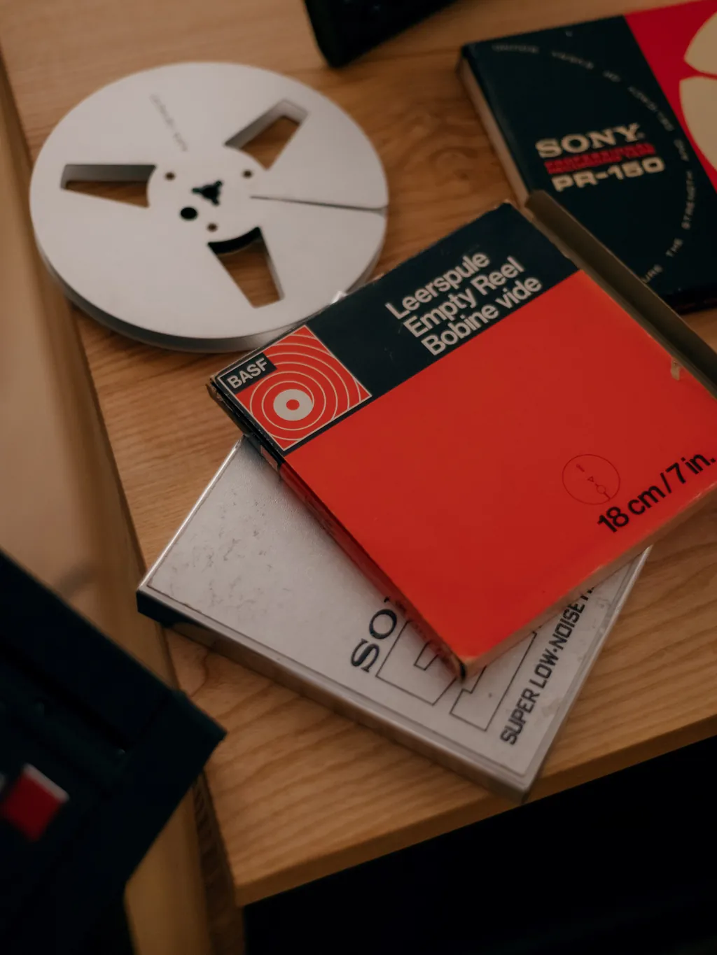 Empty reel and vintage BASF and Sony tape boxes on the studio desk